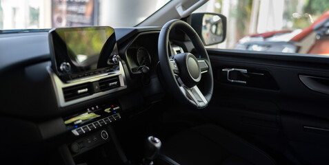 Close up Car steering wheel inside the used car cabin.Dark colored Interior of modern car. steering...