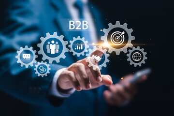B2B marketing concept, business to business, e-commerce, businessman touching virtual B2B icons for professional business and commerce collaboration. business action plan strategy.