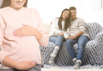 Surrogate mother and intended parents in room