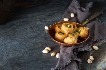 Traditional arabic dessert baklava with pistachios. Dark background - 712234351