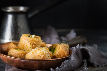 Traditional arabic dessert baklava with pistachios. Dark background - 712234564