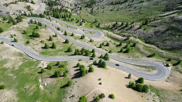 Hairpin turns at Col Izoard Mountain Pass in French Alps, France - Aerial 4k Circling