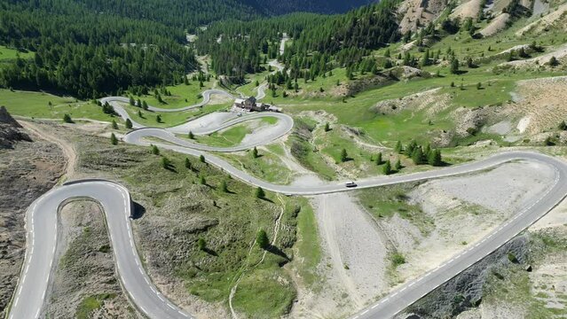 Scenic Road Col Izoard Mountain Pass in French Alps, France - Aerial 4k Reveal Tilting Up