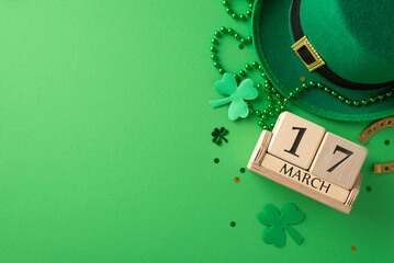St. Paddy's festivities in one frame: Top view of a wooden calendar, leprechaun hat, lucky...