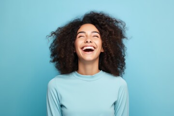 Excited woman smiling portrait on blue background ,minimal background 
