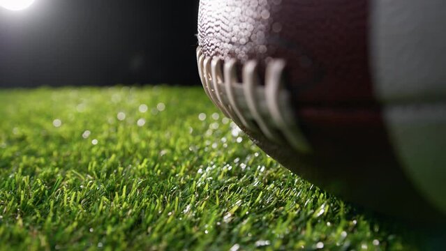 lights kissing the oval shape of a football ball