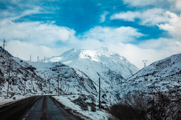 the snowy Rocky Mountain Highway with the less vegetation way in high altitude