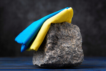 Blue and yellow fabric on granite. Colors of the Ukrainian flag