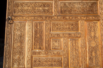 beautiful wooden door design in a historical fashion in the entrance of a historical place