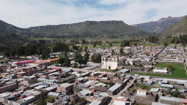 Colca Canyon, Peru: Aerial drone footage of the Yanque village with its colonial spanish church in the Colca Canyon in the Andes mountains in Peru in south America