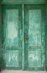 Old wooden green door. Perfect for a photo wallpaper or photo background.