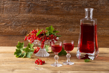 Delicious homemade currant liqueur. Served in a glass and carafe. Served with currant cake.