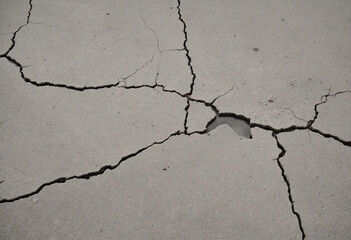 Fototapeta premium Vintage gray cracked concrete texture close-up with grunge effect.