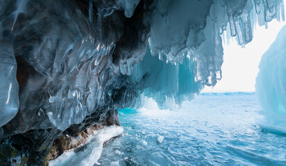Inside the turquoise ice cave - ice cave winter frozen nature background landscape - Lake Baikal,...