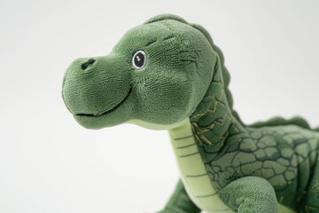 Naklejka premium Green dinosaur plush closeup on white background