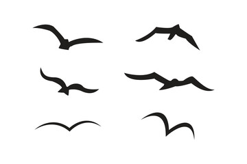 Fototapeta premium Vector illustration flying flock of birds. Beautiful flight bird silhouettes collection.