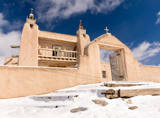 Adobe mission church in snow, New Mexico