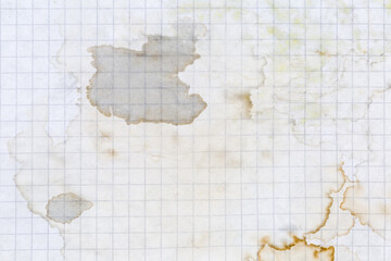 Sheet of squared paper with dried stains from spilled liquid