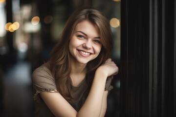 an attractive young woman smiling with her arms crossed