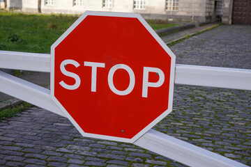 Stop sign on electronic gates. Red stop sign and barrier