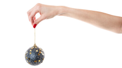 Woman's hand holding decorative Christmas ball over the white wall. Isolated on white background.