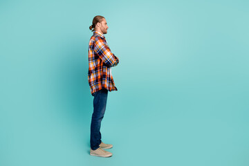 Full length side profile photo of cool guy wear flannel shirt hold arms folded look at offer empty...