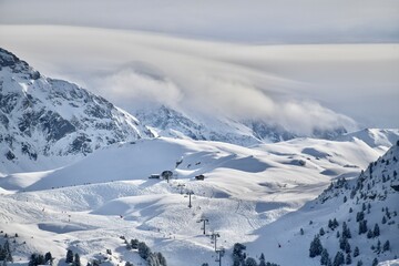Fototapeta na wymiar Ski resort in French alps by winter with its amazing slopes 