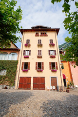 Travel by Italy. Facade of old house with flowers.
