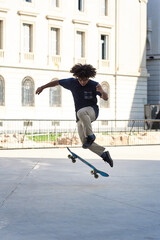 Fototapeta premium Hipster boy performing skating trick in the street.