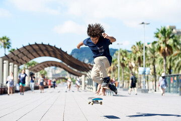 Boy performing heel flip on skateboard.