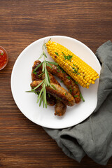 Overhead view of grilled sausage and  corn on cob summer bbq food