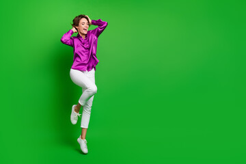 Fototapeta na wymiar Full size portrait of stunning cheerful girl jumping hands touch bob hairstyle empty space isolated on green color background