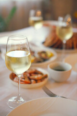 People fine dining seafood and white wine