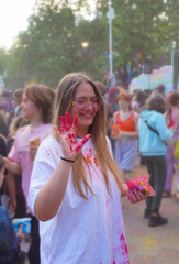 Holi festival of colors, a young woman celebrates the beginning of spring and showers each other with colorful paints
