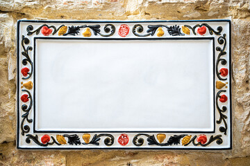 Traditional ceramic home sign board on wall