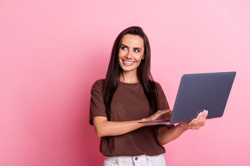 Fototapeta premium Photo of smiling business woman successful monetize content in social media using laptop looking mockup isolated on pink color background