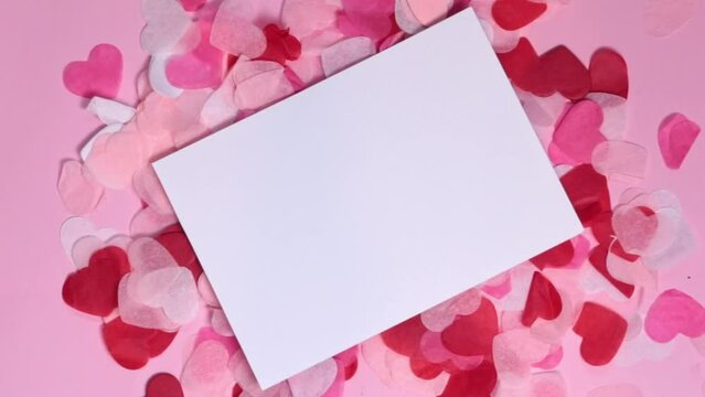 Happy Valentine's Day card on a background of paper hearts. Place for text