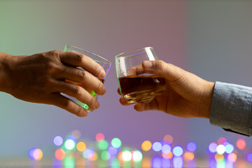 Close-up of two men clinking whiskey glasses. drink alcohol