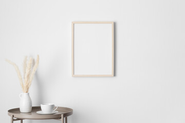 Wooden frame mockup on the wall with a pampas decoration.