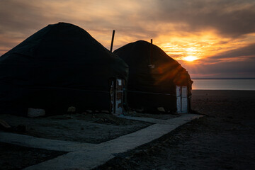 Yurt Camp by the Aral Sea against background of a beautiful blue sky from dawn in the early morning.. Uzbekistan