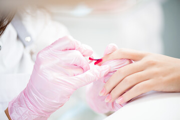 Hands in gloves cares about hand nails. Manicure beauty salon.