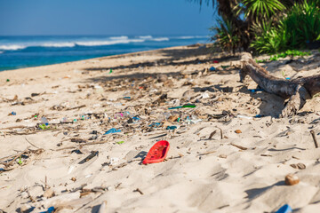 Pollution by plastic rubbish on coastline. Ocean beach and plastic trash in Bali island.
