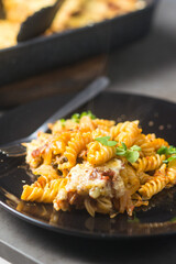 Italian pasta in a plate on a baking sheet background