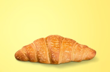 Tasty fresh golden croissant on desk