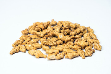 A treat for cats and kittens is a fish-shaped catnip cookie close-up.