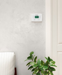 digital programmable thermostat, on the wall. 3d illustration - 712358988