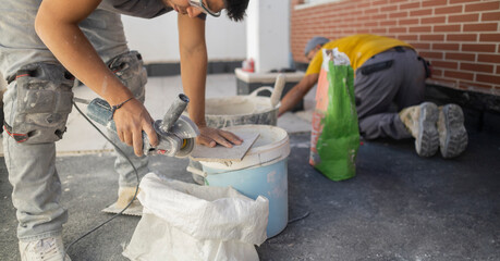 Lifestyle shot of an adult male construction worker in work clothes as he lays cement
