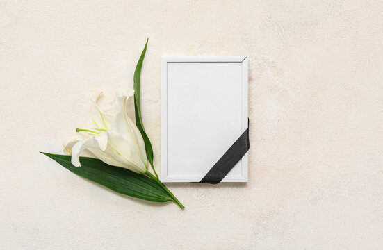 Blank funeral frame with lily flower on light background