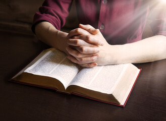Woman's hands holding a bible
