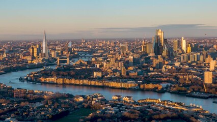 Beautiful sunrise timelapse view of the urban skyline of London, England, with soft orange sunlight reflecting at the skyscrapers - Powered by Adobe